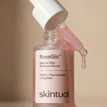 RoseGlo serum being poured into the bottle