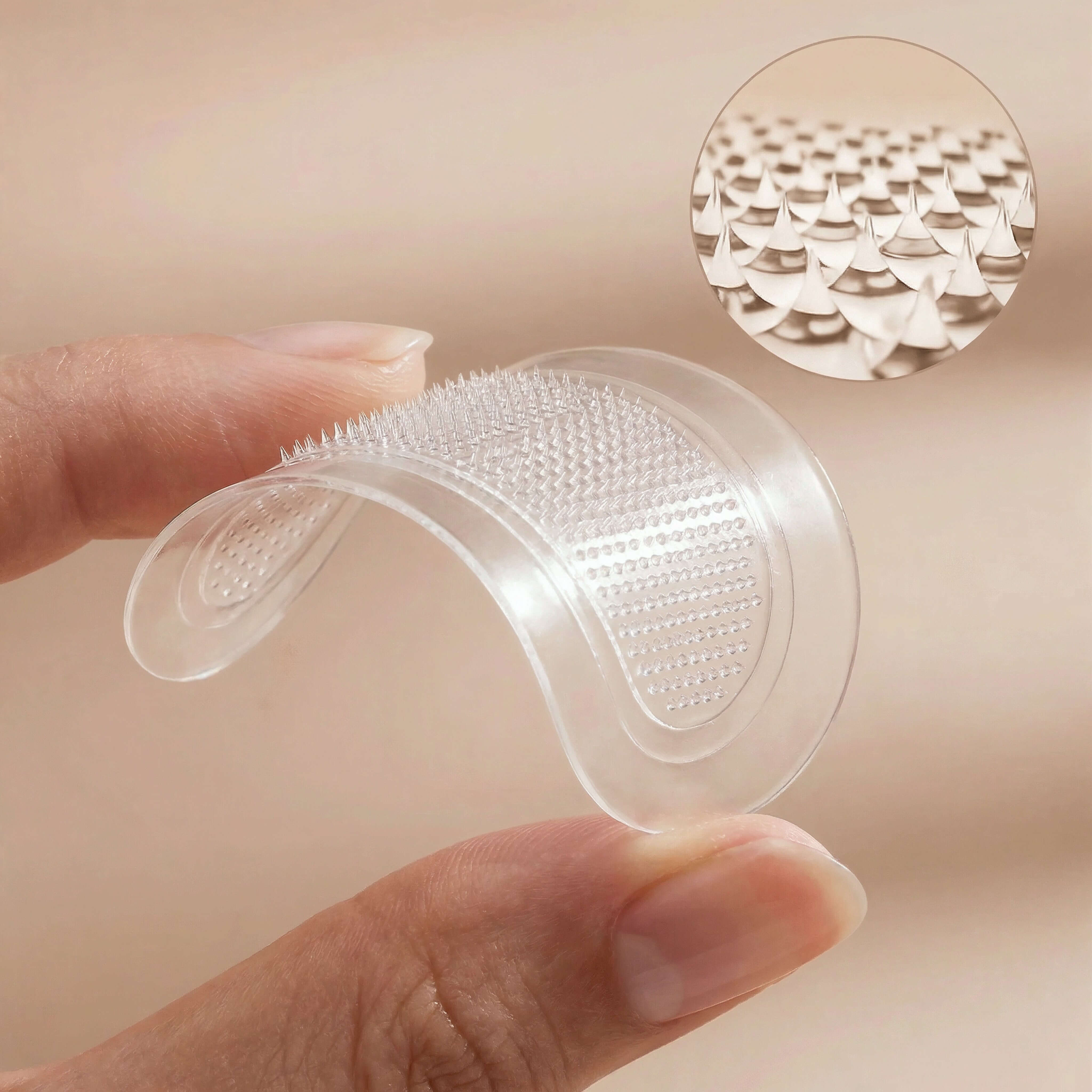 Closeup of Skintual under eye patches held by a hand with a close-up inset showing its texture.